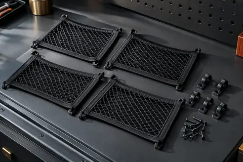 Quatre filets noirs en maille élastique fixés sur un panneau intérieur de coffre automobile